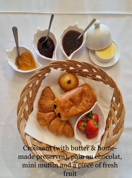 Croissant (with butter & home-made preserves), pain au chocolat, mini muffin and a piece of fresh fruit