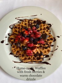 Home-made Waffles with fresh berries & warm chocolate drizzle