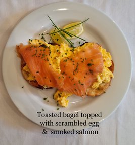 Toasted bagel topped with scrambled egg  &  smoked salmon